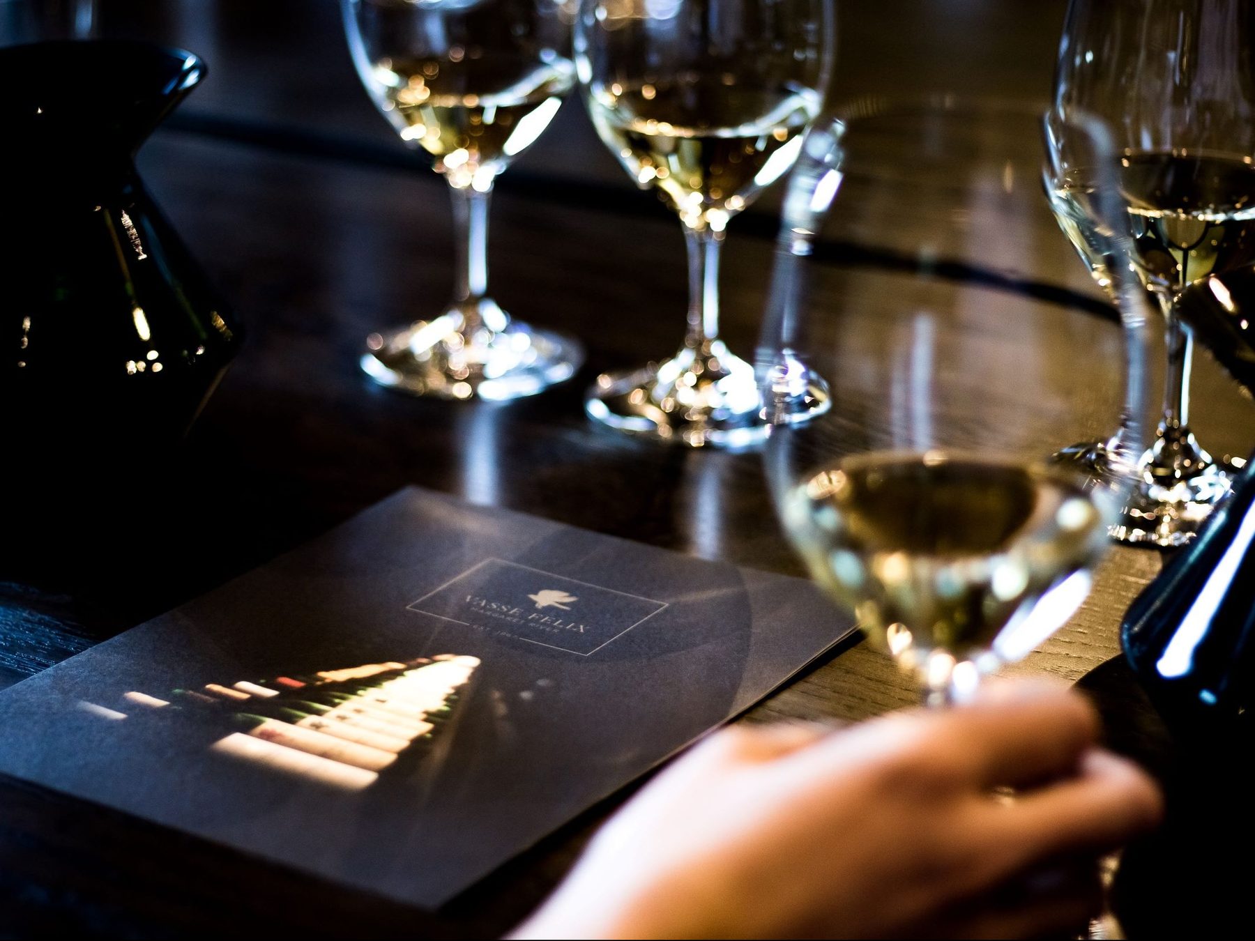 A flight of white wines lined up on a Margaret River tasting bench