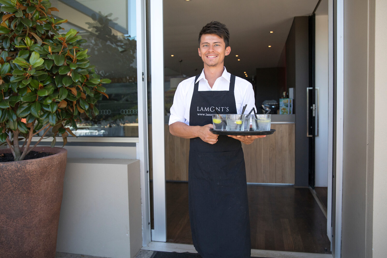 A waiter carrying breakfast out from Lamont's