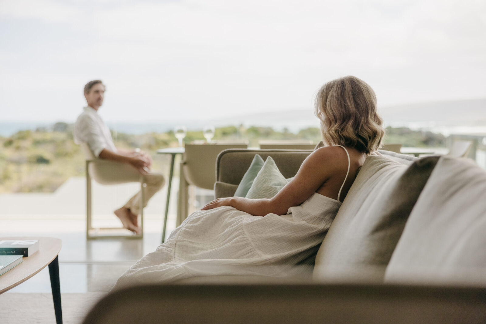 Guests in the lounge at the end of the day, the ocean through the glass