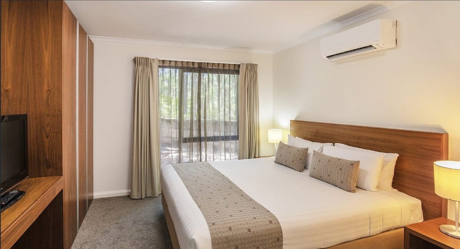 The separate bedroom, with a king bed and its own balcony