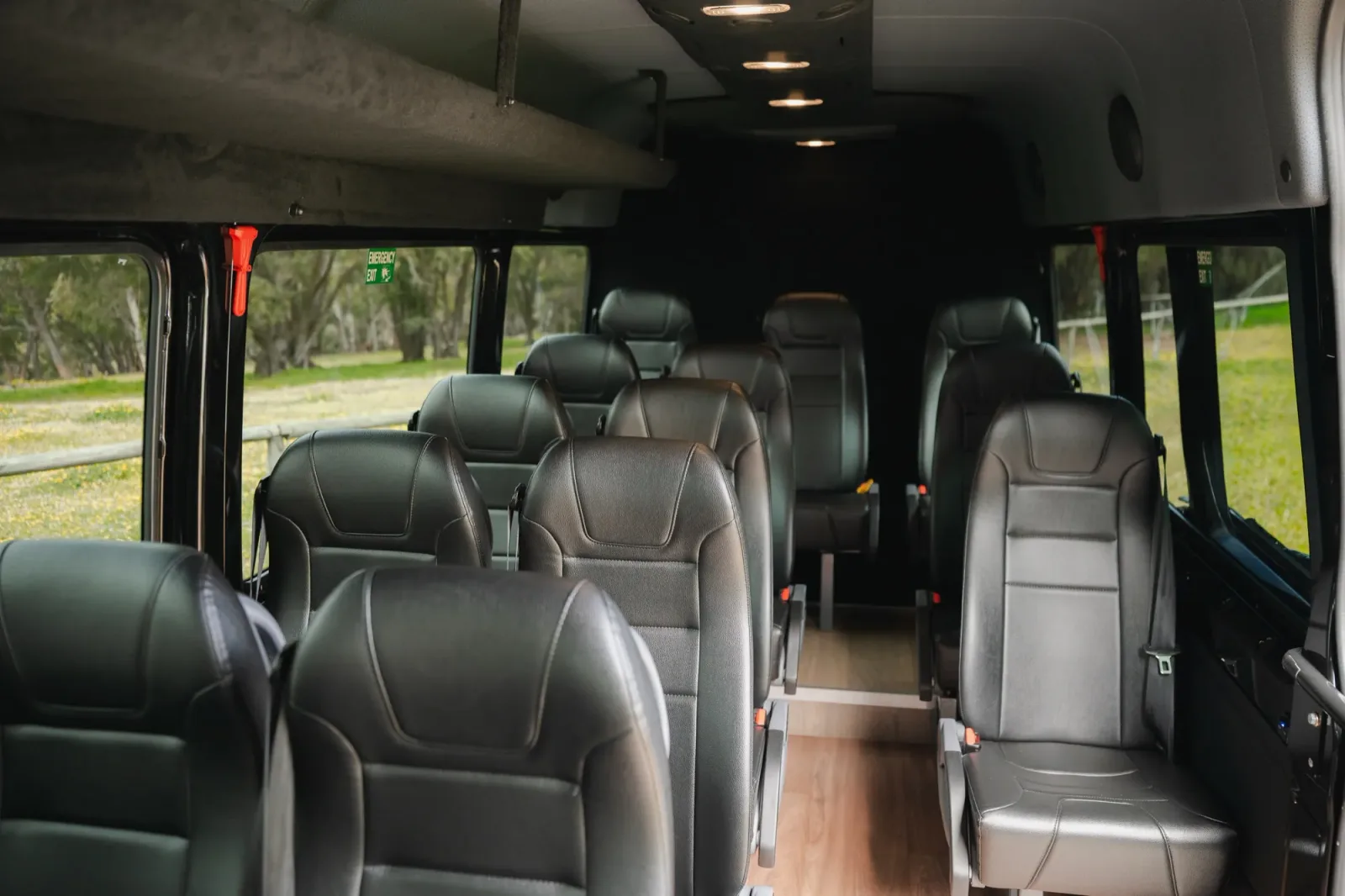 Inside rear view of McLeod Tours Mercedes-Benz Sprinter, 13 black leather reclining seats